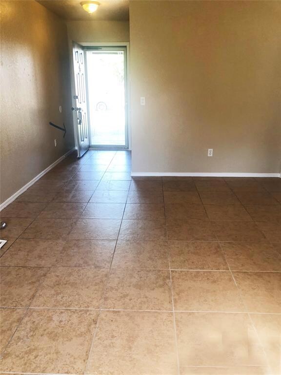 Unfurnished room with tile floors