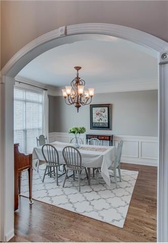 A delightful arched doorway leads to a gorgeous dining room with wainscoting. This room is to the left as one enters the home and potentially could be an office if needed.