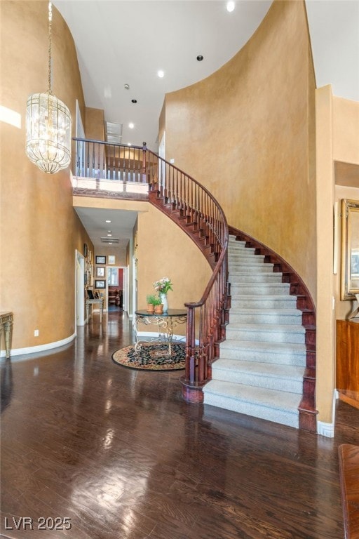 Foyer entrance featuring stairway, a towering ceil