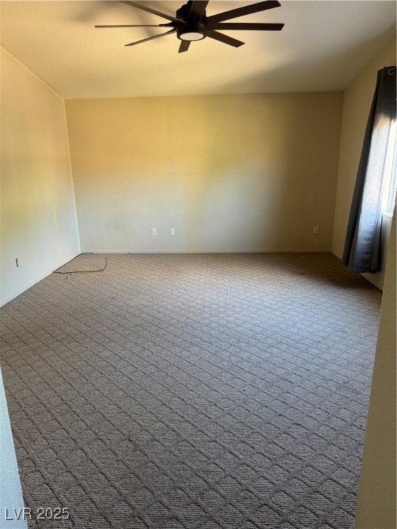 Carpeted empty room featuring a ceiling fan