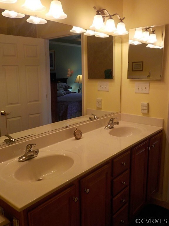 Master bath with tile floor and double vanity
