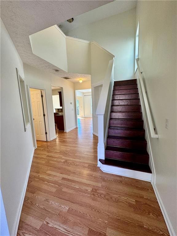 Stairs with wood finished floors, baseboards