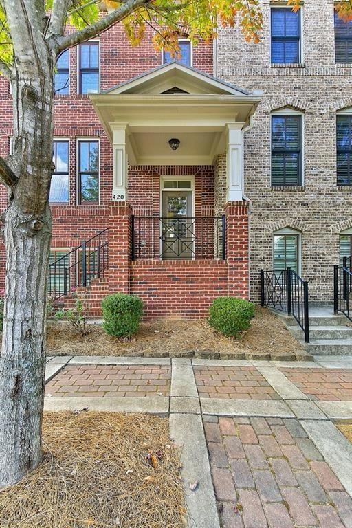 Property entrance featuring brick siding