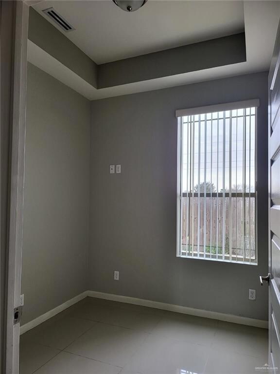 Unfurnished room with plenty of natural light and tile patterned floors