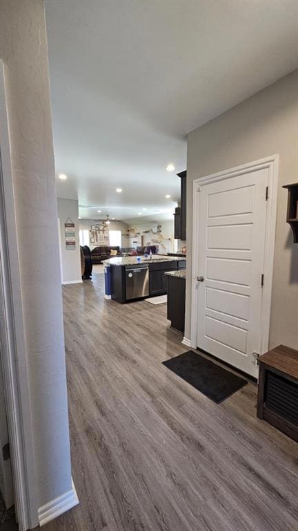 Entrance foyer with wood finished floors and recessed lighting