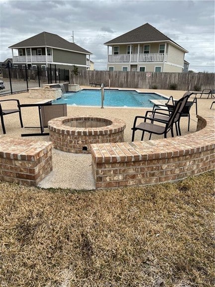 View of pool with a fenced backyard, a hot tub, an