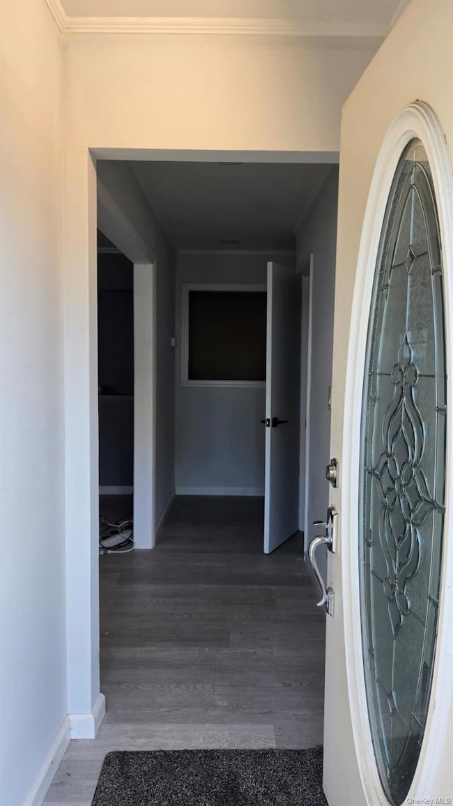 Entryway with baseboards and light wood-style floors