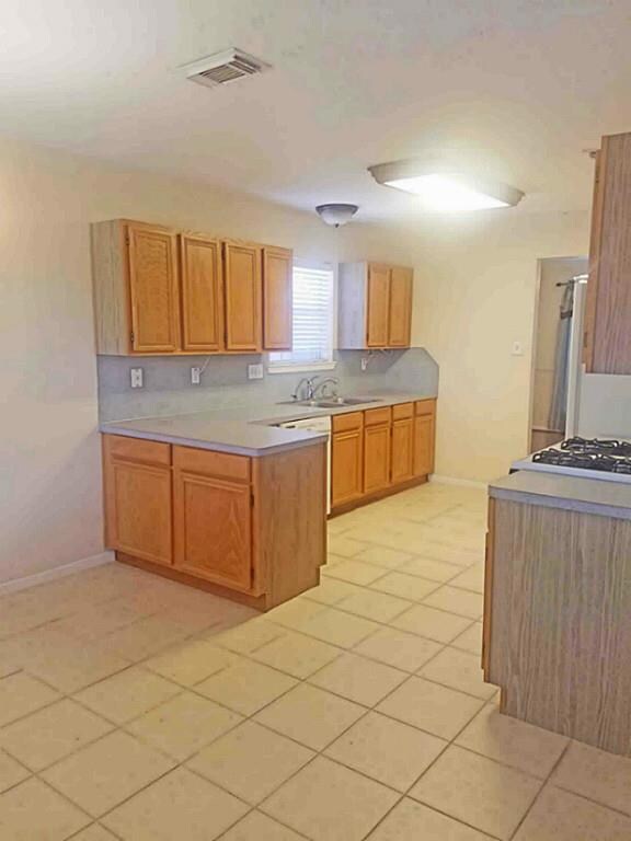 View of the Kitchen from the Den showing double sink with window above.