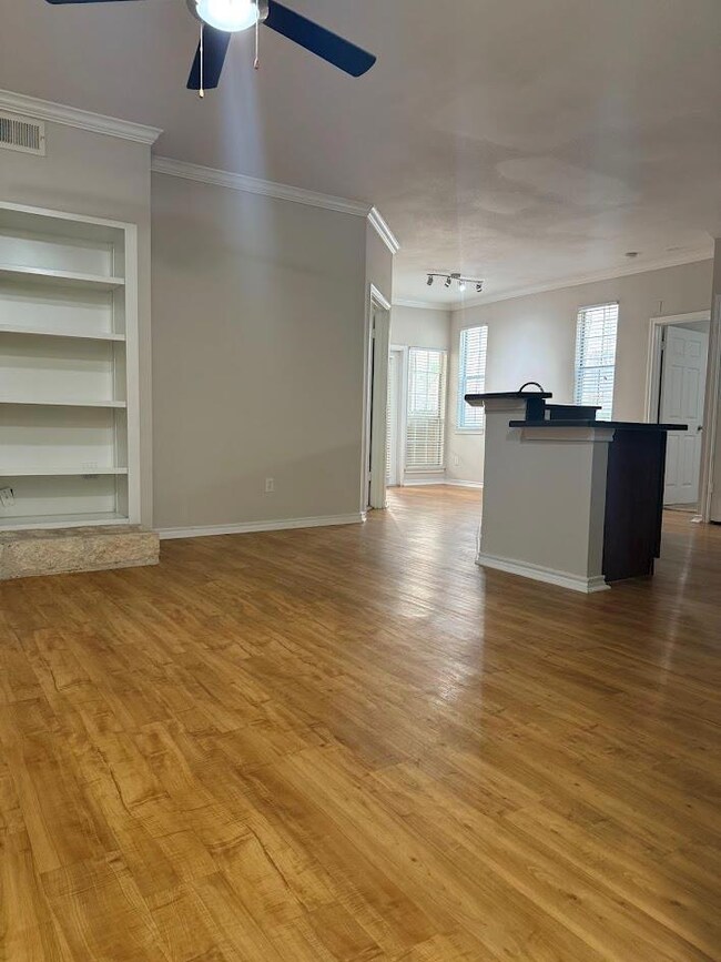 Unfurnished living room with crown molding, ceili
