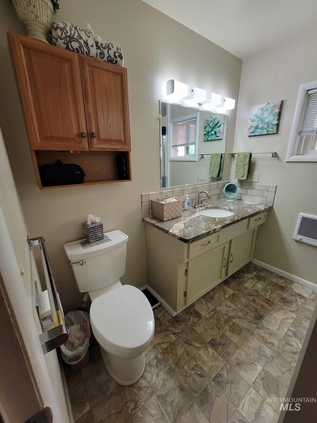Bathroom featuring vanity and stone finish flooring