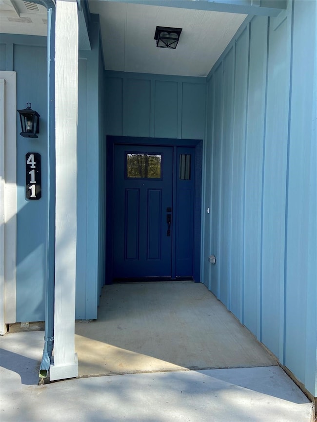 Doorway to property with board and batten siding