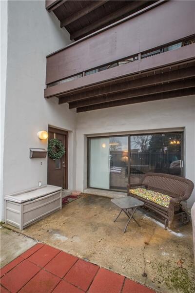 The front entry is covered by the upper level deck