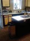 Island kitchen with tile floors.