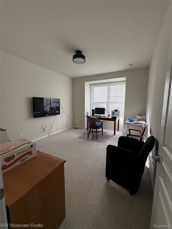 Carpeted home office with baseboards