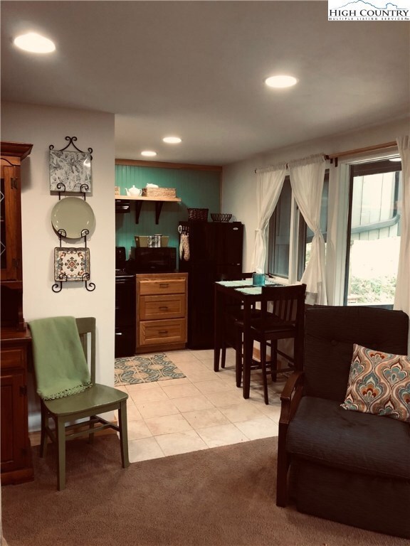 Living room leads in to kitchen and breakfast area