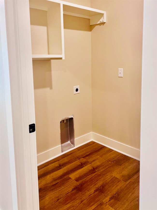 Laundry area featuring electric dryer hookup and wood finished floors
