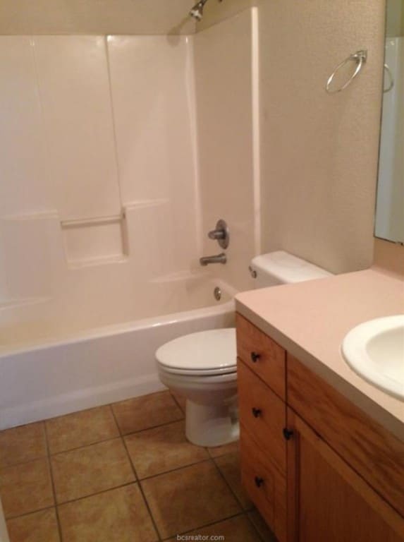Bathroom featuring tile patterned floors, toilet,