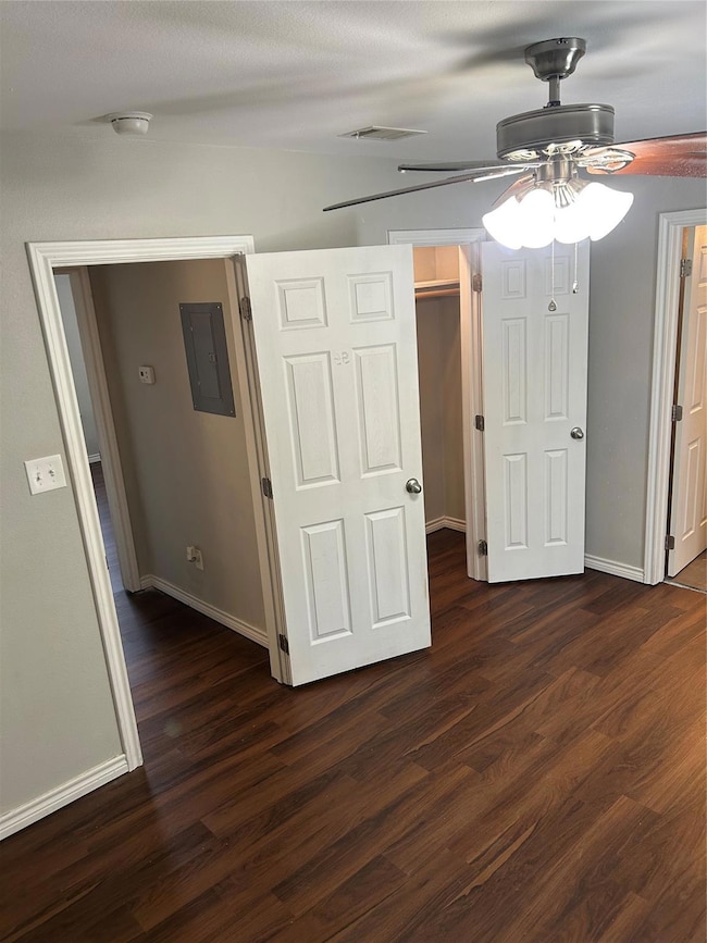 Unfurnished bedroom 2 with ceiling fan, dark wood-