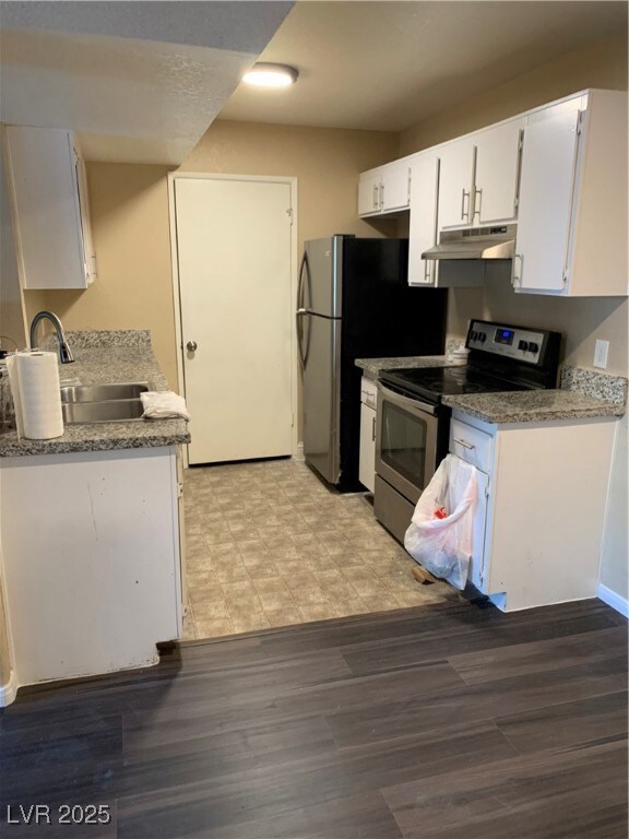 Kitchen with a sink, ventilation hood, white cabin