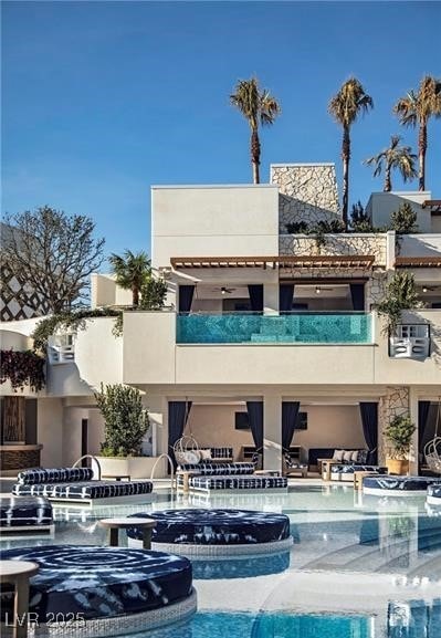 Back of property featuring stucco siding