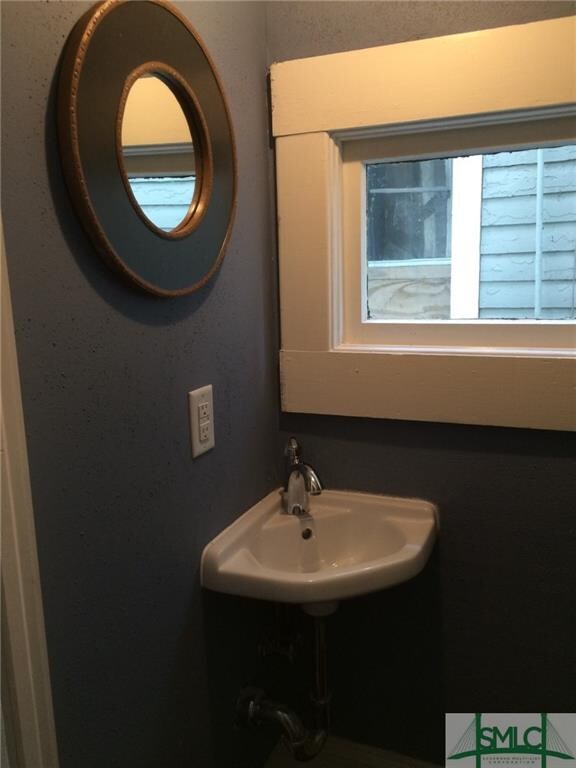 Powder room at end of front hallway
