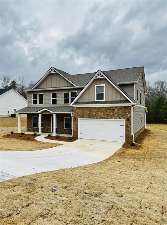 Craftsman-style home with brick siding, board and batten siding, roof with shingles, a garage, and driveway