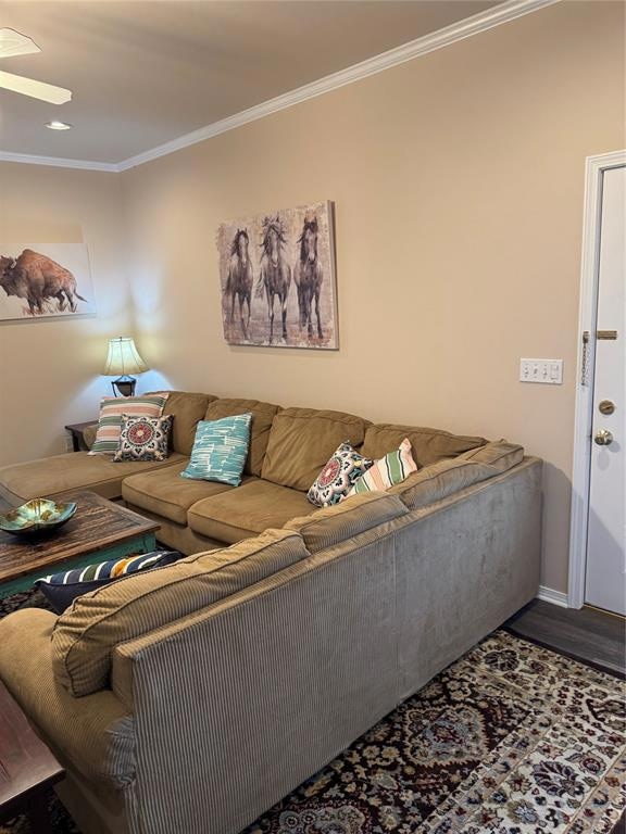 Living room featuring ornamental molding, wood finished floors, and recessed lighting