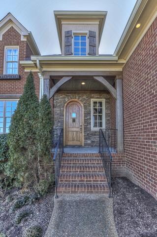 Stone and cedar accents for the covered front entrance. Night lighting and full irrigation to enhance the home setting.
