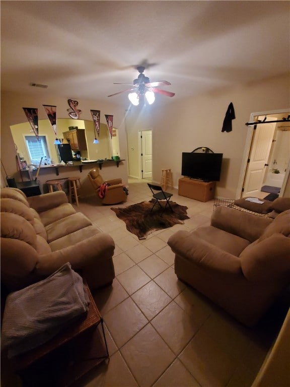 Tiled living room featuring ceiling fan