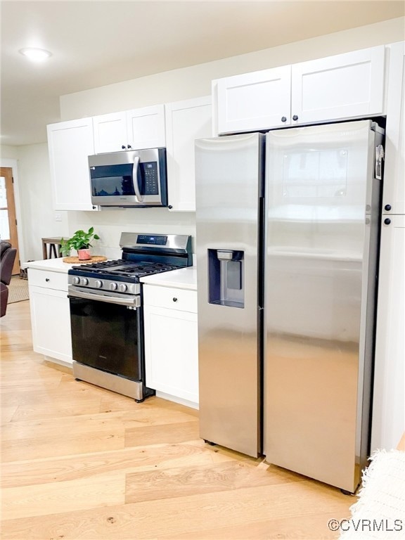 Kitchen with light wood-type flooring, appliances