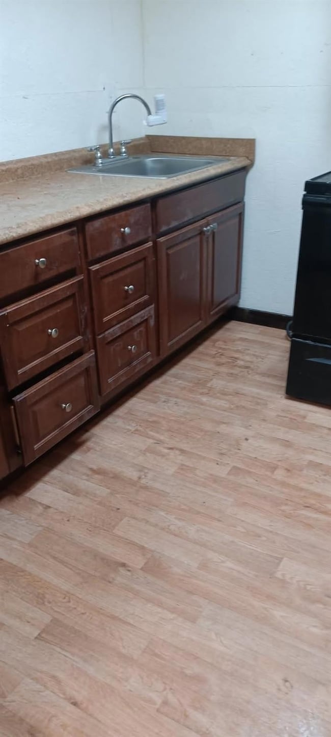 Kitchen featuring black electric range oven, light