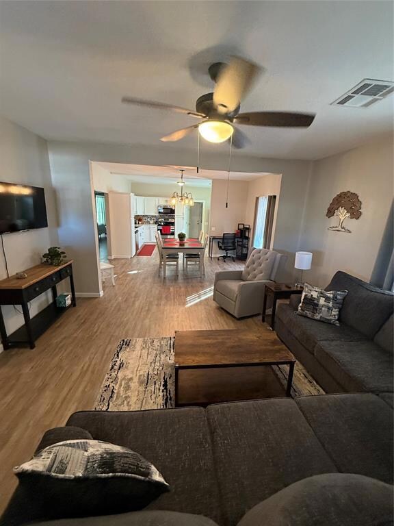 Living room looking into dining room and kitchen w