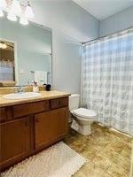 Bathroom featuring vanity, a shower with shower curtain, and a chandelier
