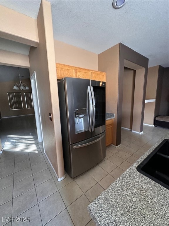 Kitchen featuring light tile patterned floors, sta