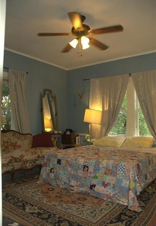 Bedroom with ornamental molding and ceiling fan