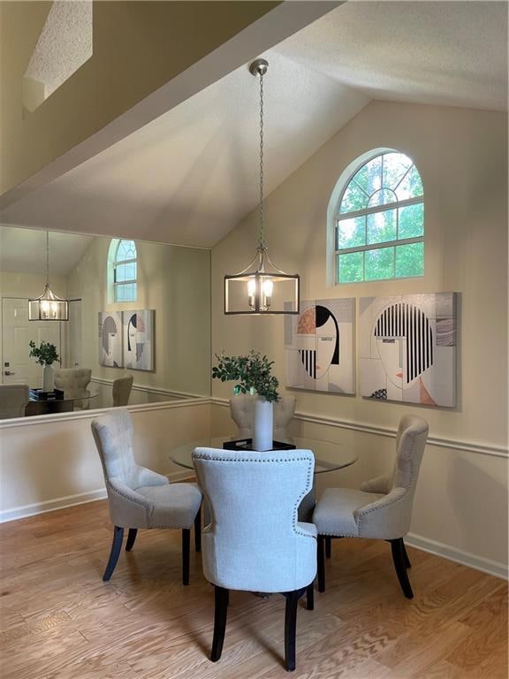 Dining space featuring a chandelier, vaulted ceili