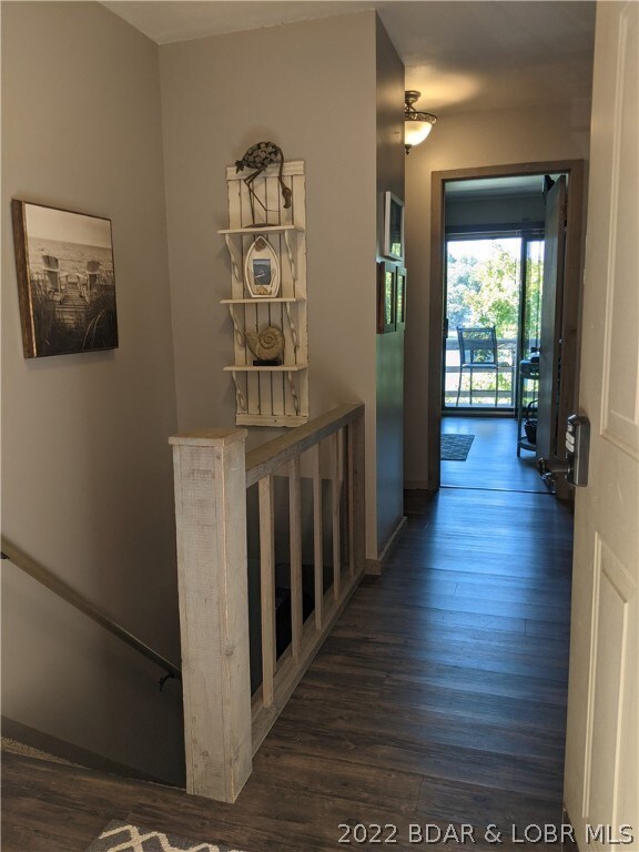 Entry on upper level to 3 bedrooms, 2 baths, steps to lower level with large kitchen, dining area, laundry with bathroom,  living room, 4 th bedroom,