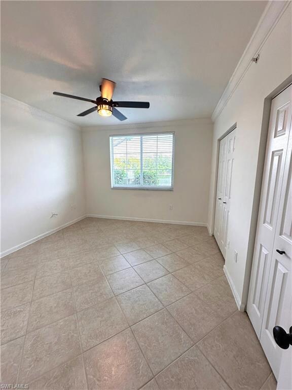 Unfurnished bedroom with baseboards, ornamental mo