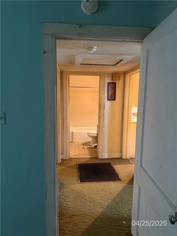 Hallway featuring carpet flooring