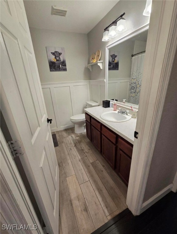 Bathroom featuring vanity, hardwood / wood-style f