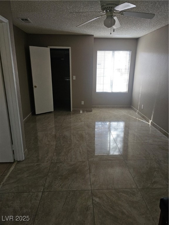 Empty room with visible vents, baseboards, a ceili