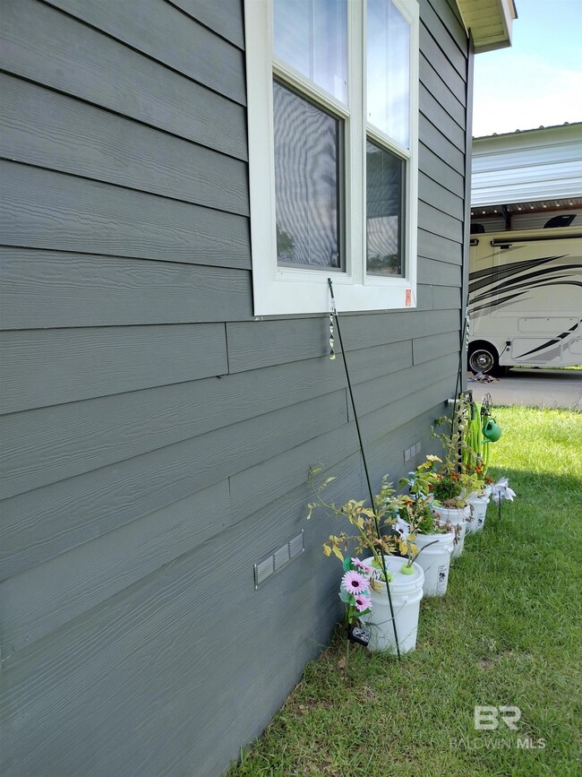 View of side of property with a yard