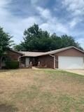 View of front of property featuring a garage and a