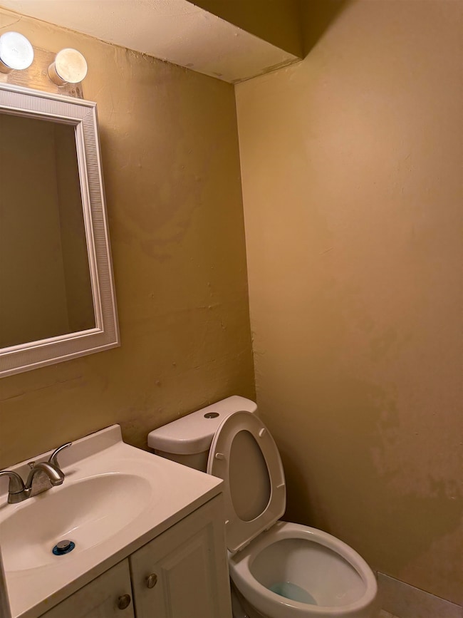 Half bath featuring toilet and vanity