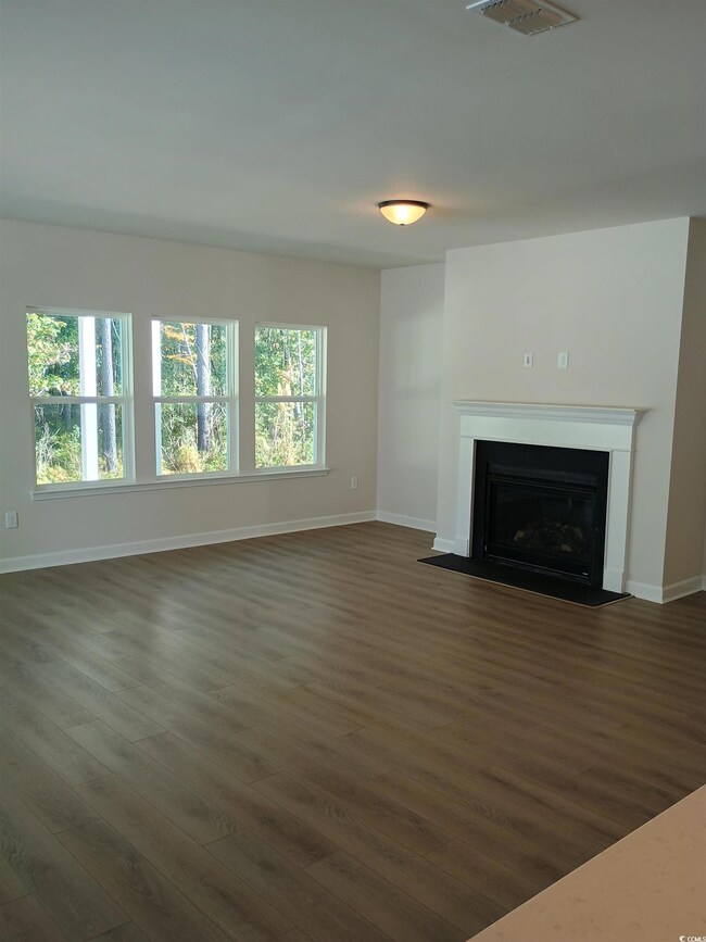 Unfurnished living room with plenty of natural lig