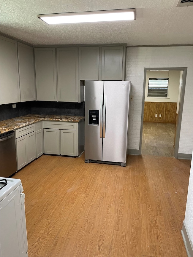 Bright kitchen with modern gray cabinets, granite