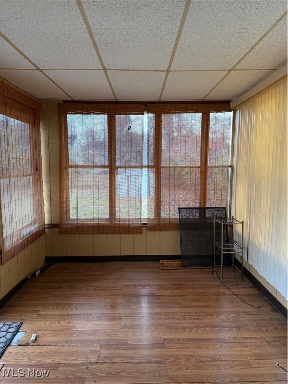 Unfurnished sunroom featuring radiator