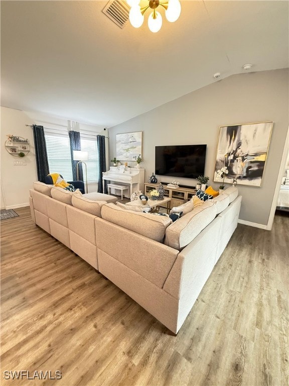 Living area with wood finished floors, lofted ceil