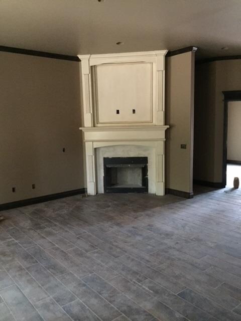 Stately glazed woodwork fireplace contrasting with