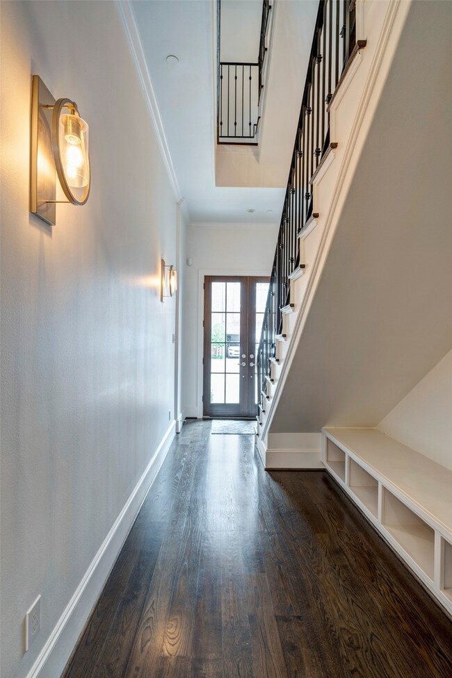 Entry hall with tall ceilings and built-in bench t